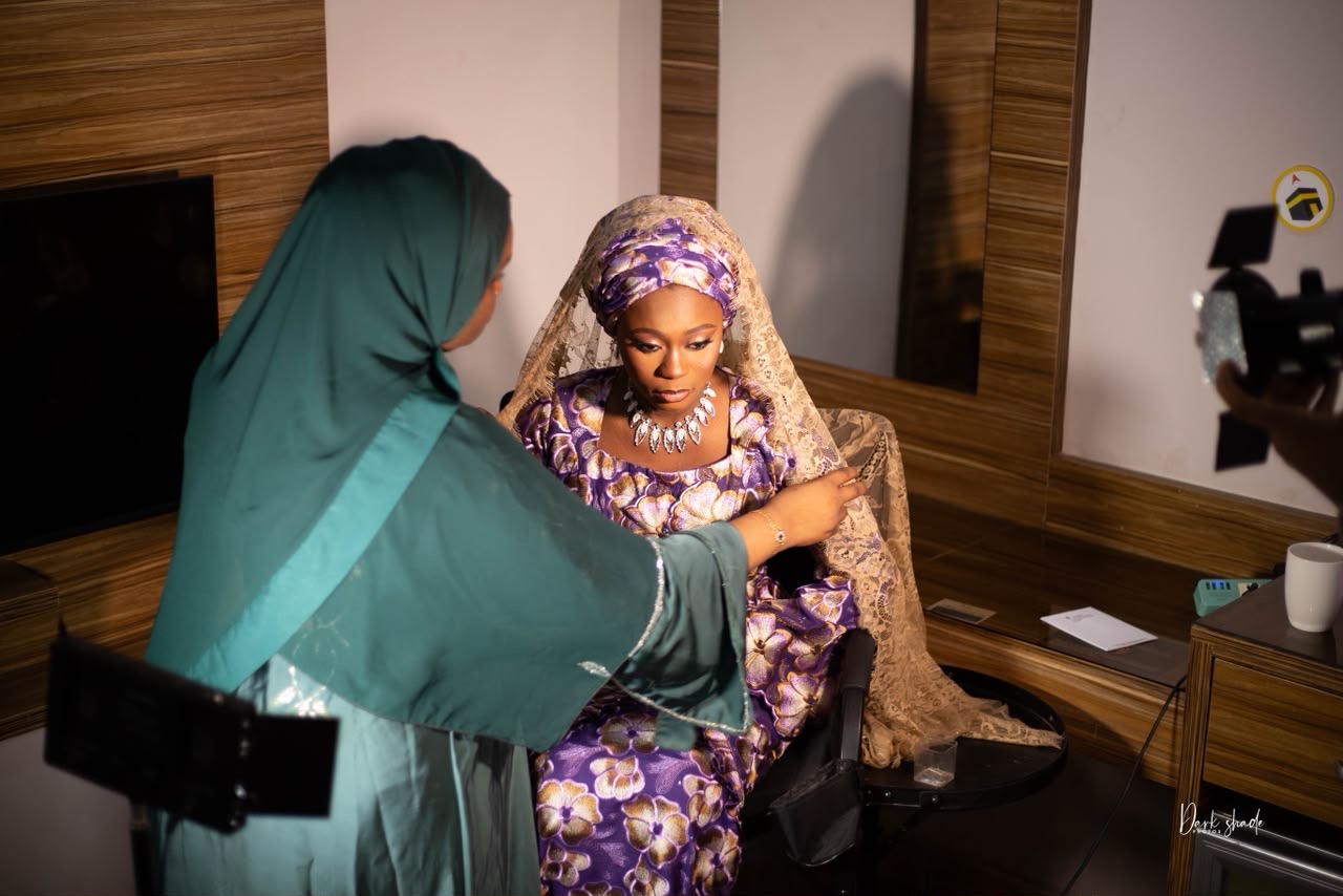 Zuzu styling a client's bridal glam and hijab during a session